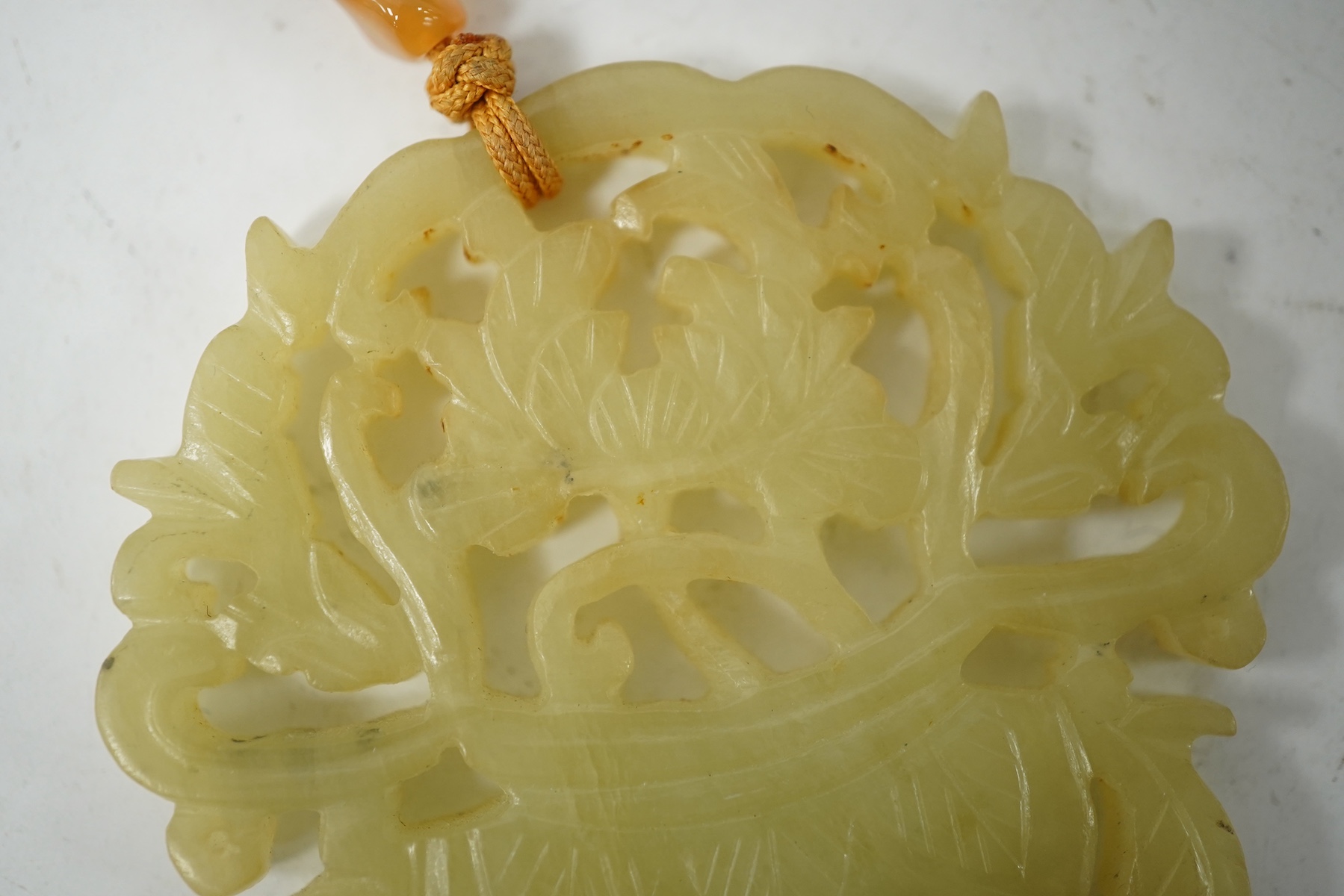 A Chinese pale celadon jade 'basket of flowers' pendant plaque, 19th century, 6cm wide. Condition - good